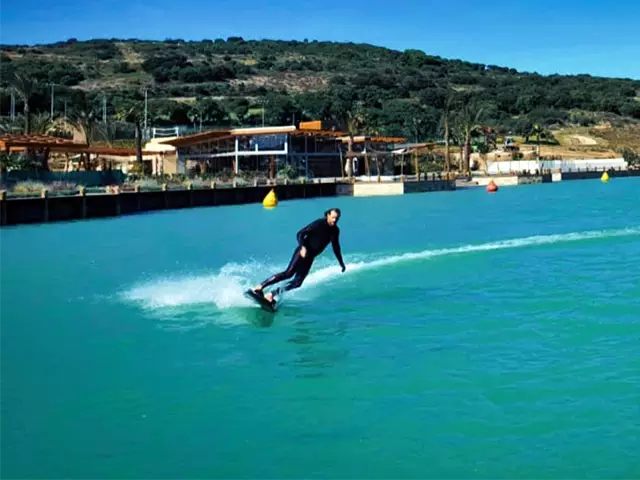 Wayne riding a jetboard on the La Reserva Club watersports lagoon.